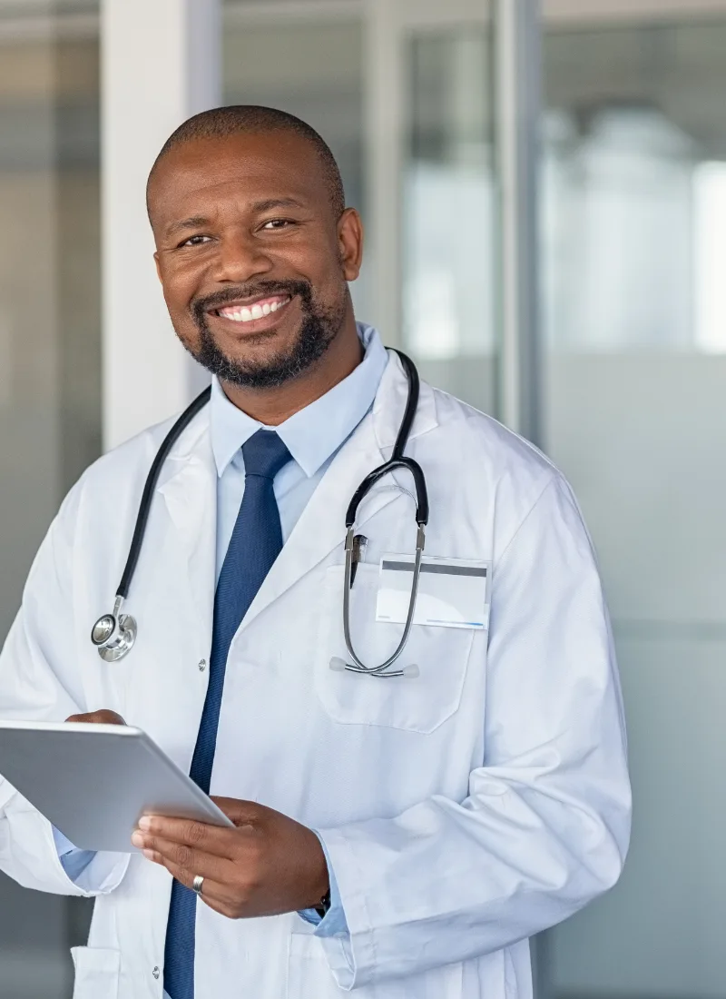 board certified family doctor with tablet in medical clinic
